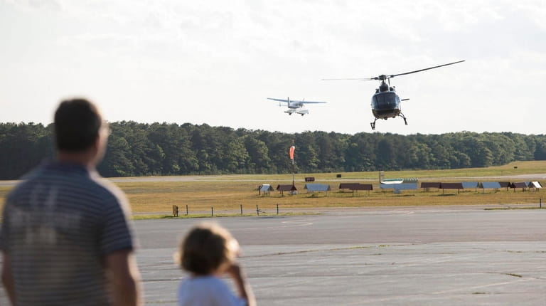 Helicopters and planes fly in and out of the East Hampton...