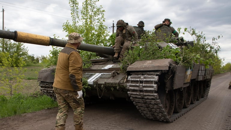 A Ukrainian tank rides on the road near Bakhmut, Donetsk...