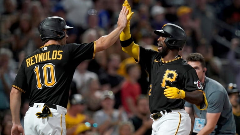 Pittsburgh Pirates' Andrew McCutchen celebrates with Bryan Reynolds after he...