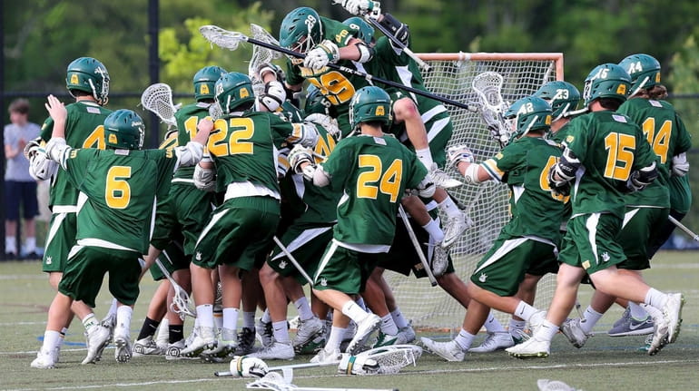 Ward Melville celebrates their 11-10 victory over Northport in a...