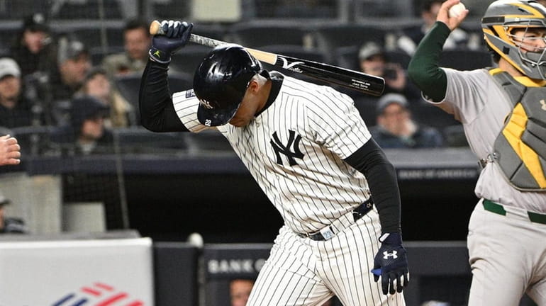 Yankees rightfielder Juan Soto slams his bat down after striking...