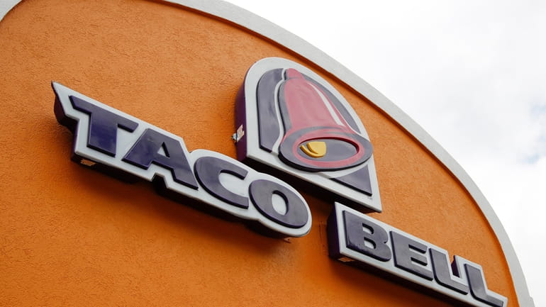 A sign hangs at a Taco Bell on May 23,...