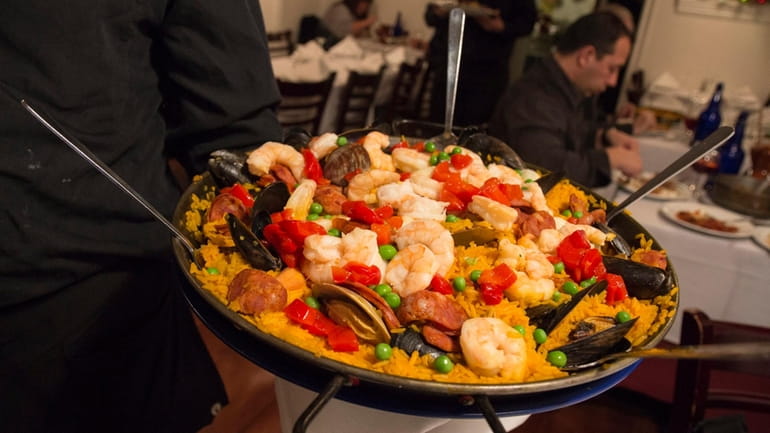 Paella Valenciana, which comes with clams, mussels, shrimp, scallops, chicken...
