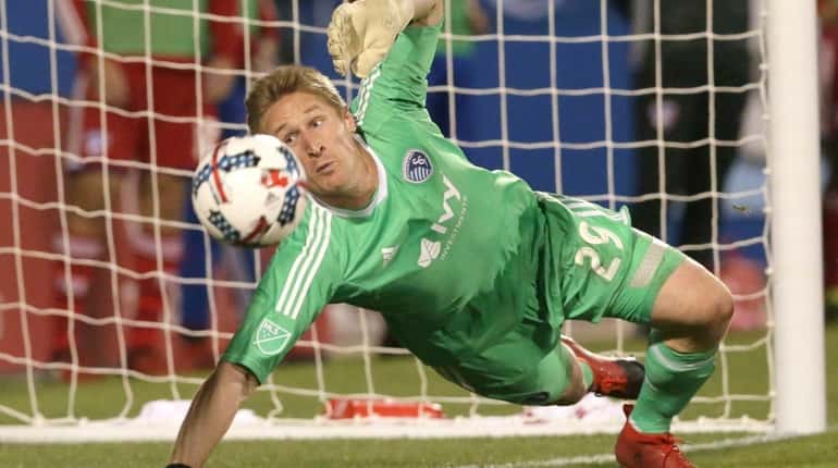 Sporting Kansas City goalkeeper Tim Melia defends during an MLS...