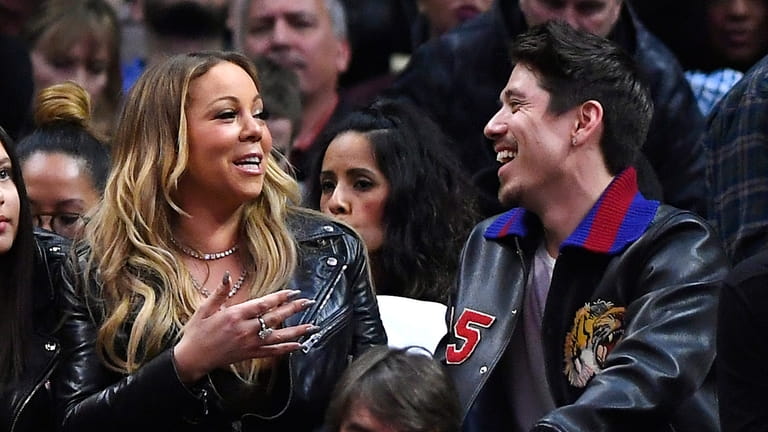 Mariah Carey and Bryan Tanaka at an NBA basketball game in...