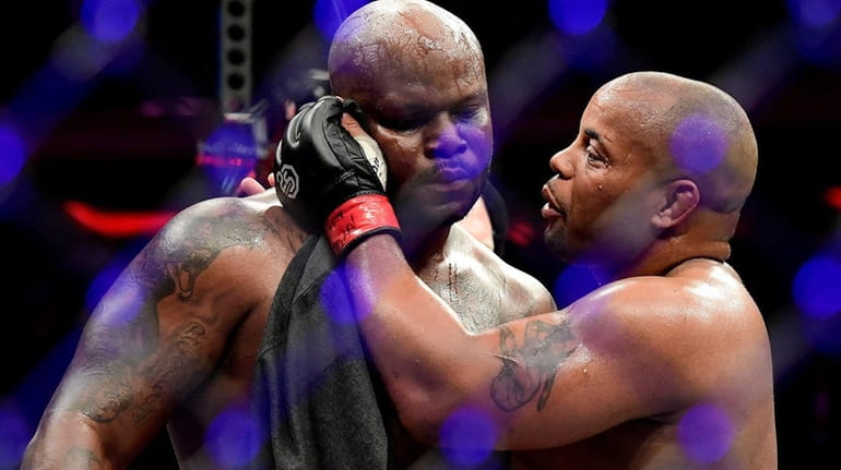Daniel Cormier, right, talks with Derrick after defeating him by...