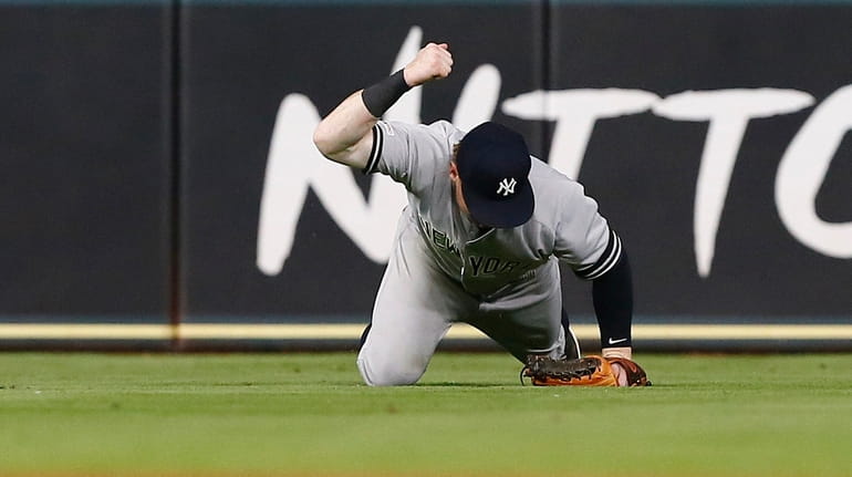Clint Frazier of the Yankees pounds his fist into the...