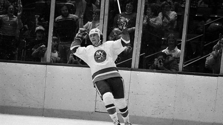 New York Islanders winger Mike Bossy cheers after his hat...