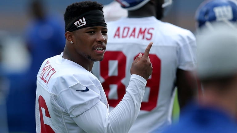 Giants running back Saquon Barkley gestures during training camp on Aug....