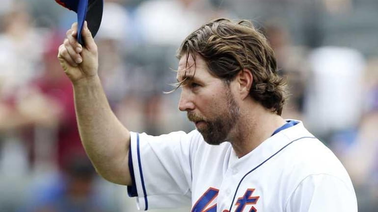 New York Mets starting pitcher R.A. Dickey acknowledges the crowd...