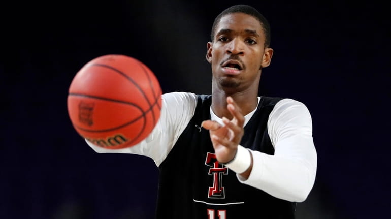 Texas Tech's Tariq Owens warms up during a practice session for...