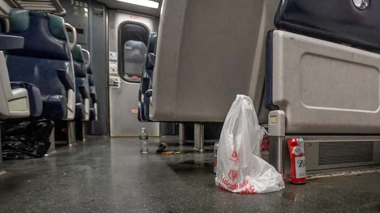 Trash is strewn about the floor and seats of an...