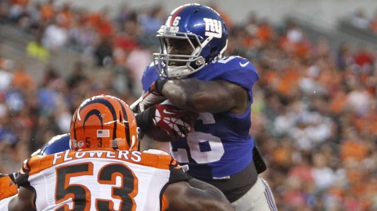 New York Giants running back Orleans Darkwa goes up and...