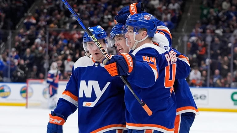 Jean-Gabriel Pageau (44) celebrates with Islanders teammates after scoring against...