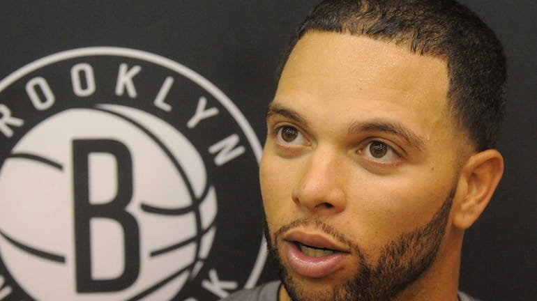 Deron Williams talks to the media after team practice held...