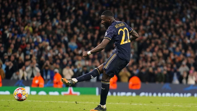 Real Madrid's Antonio Rudiger scores the winning penalty during the...