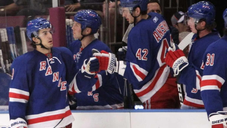 The Rangers' Michael Del Zotto celebrates with teammates after scoring...