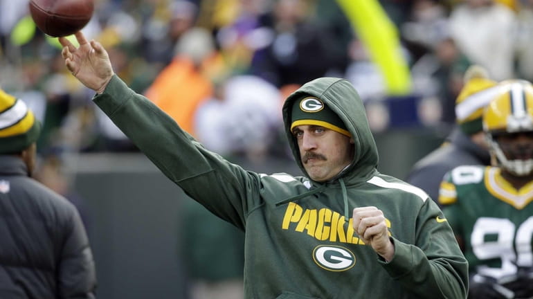 Green Bay Packers quarterback Aaron Rodgers throws before a game...