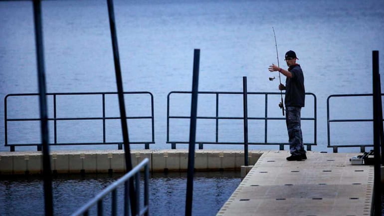 17-year-old Craig Lyon fishes in Lake Ronkonkoma. (May 23, 2011)