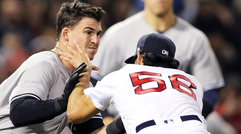 Tyler Austin of the Yankees fights Joe Kelly of the...