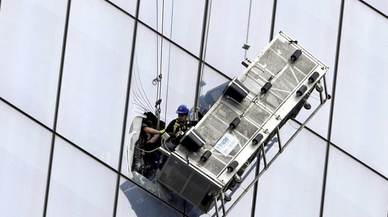 FDNY members rescue two window washers after their scaffolding was...