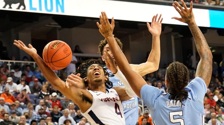 Virginia guard Armaan Franklin (4) is fouled as he drives...