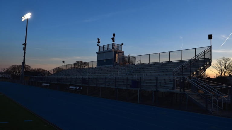 Empty bleachers are visible from the Oceanside football field during teampractice...