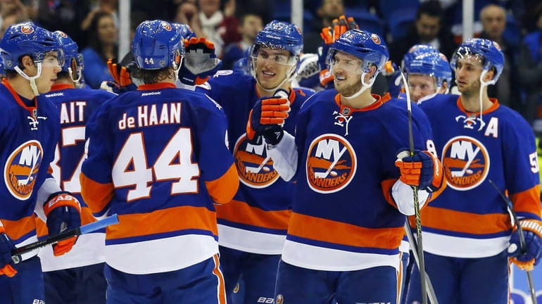 The New York Islanders celebrate after defeating the New Jersey...