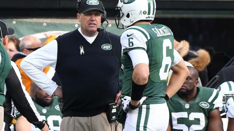 Jets head coach Rex Ryan talks with quarterback Mark Sanchez...