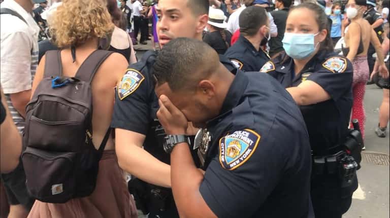A cop at an LGBTQ Pride march writhes in pain...