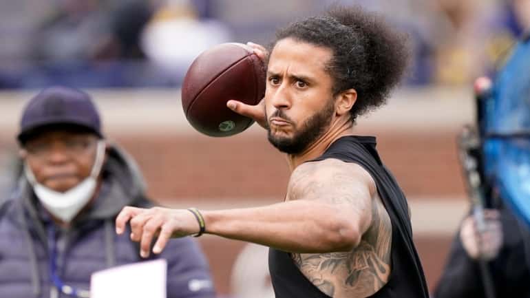 Colin Kaepernick throws during halftime of an NCAA college football...