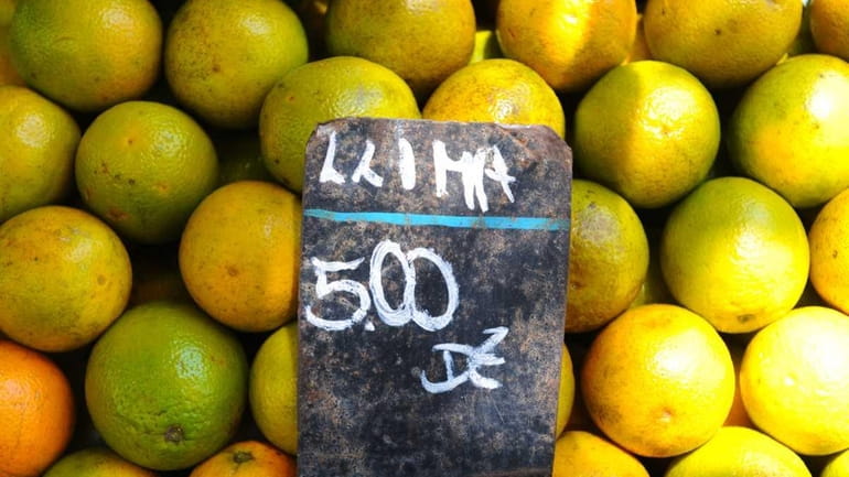 Picture of oranges for sale are viewed at a market...