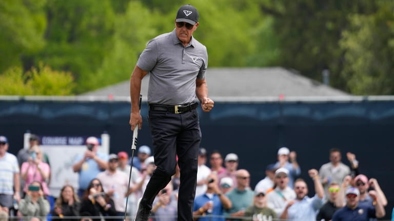 Phil Mickelson celebrates after a birdie on the fifth hole...