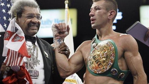 Boxing promoter Don King, left, congratulates Tomaz Adamek, of Poland,...