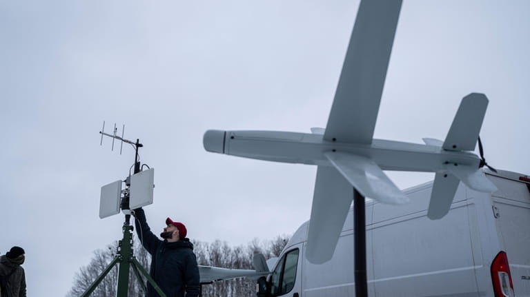 An engineer assembles an antenna for guiding an exploding drone...