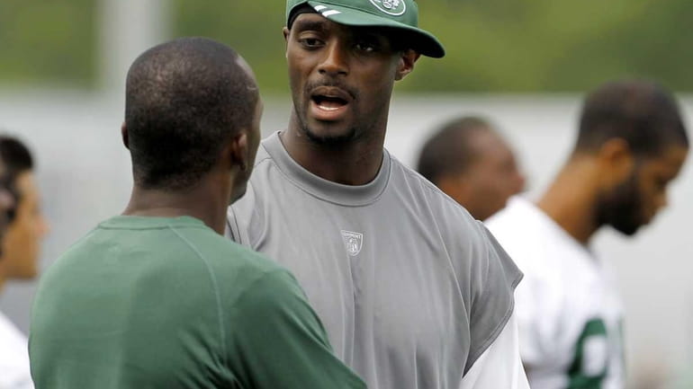 New York Jets wide receiver Plaxico Burress, right, talks to...