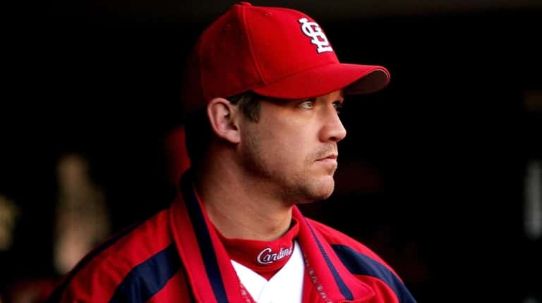 Scott Rolen of the Cardinals looks on from the dugout during the...