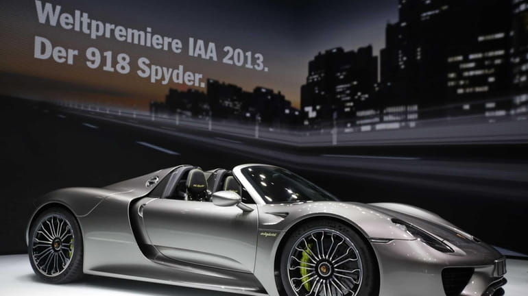 A Porsche 918 Spyder automobile stands on display at the...