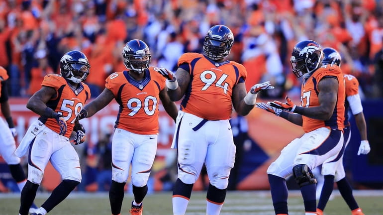 Terrance Knighton of the Denver Broncos and teammates celebrate after...