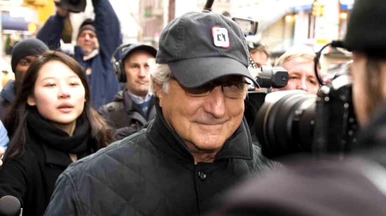 Bernie Madoff walks down Lexington Avenue to his Manhattan apartment,...