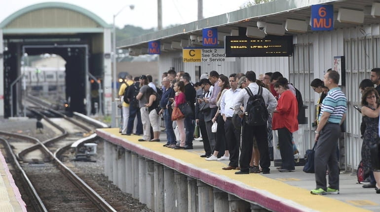 LIRR commuters at the Ronkonkoma station wait for a train...