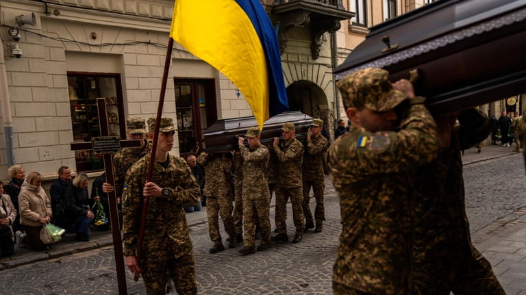 Soldiers carry the coffins of two Ukrainian army sergeants Tomkevych...