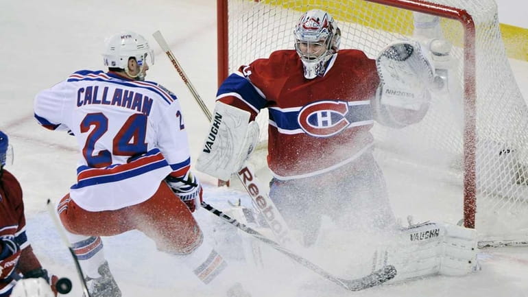 New York Rangers' Ryan Callahan, left, slides in on Montreal...