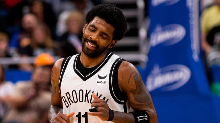 Kyrie Irving of the Nets smiles during an NBA game against...