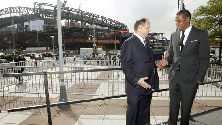 Nets part-owner Jay-Z (right) shakes hands with Barclays Center developer...