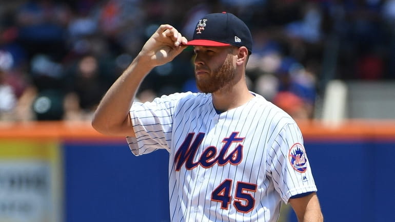 New York Mets starting pitcher Zack Wheeler reacts against the...