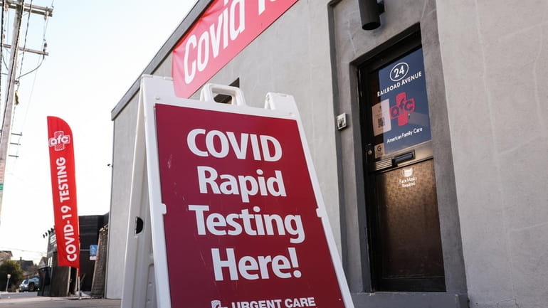 An advertisement touts COVID-19 rapid testing outside of the AFC...