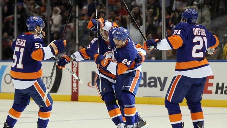 Islanders' Steve Staios celebrates his third period goal against the...