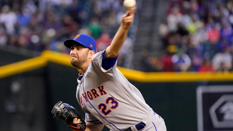 New York Mets starting pitcher David Peterson (23) throws against...