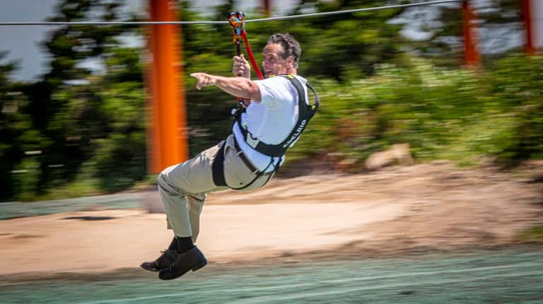 Gov. Andrew M. Cuomo tries out the new zip ride...
